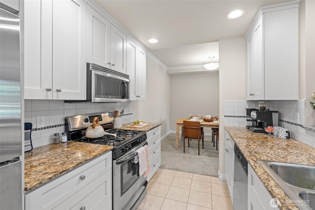 1310 Old Fairhaven Pkwy Unit 102, Bellingham, WA 98225 - kitchen with appliances with stainless steel finishes, light carpet, white cabinetry, tasteful backsplash, and recessed lighting