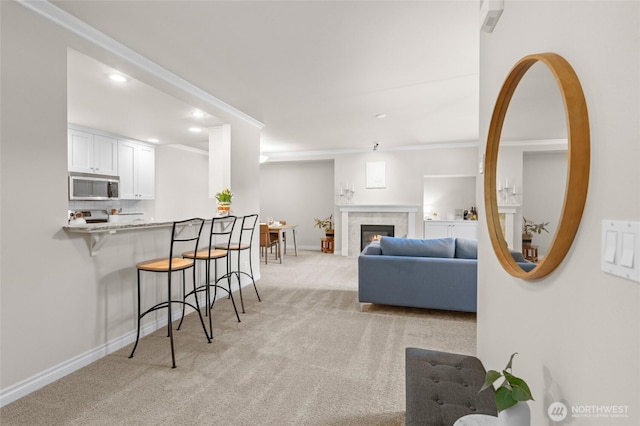 1310 Old Fairhaven Pkwy Unit 102, Bellingham, WA 98225 - living area featuring light colored carpet, recessed lighting, crown molding, baseboards, and a fireplace