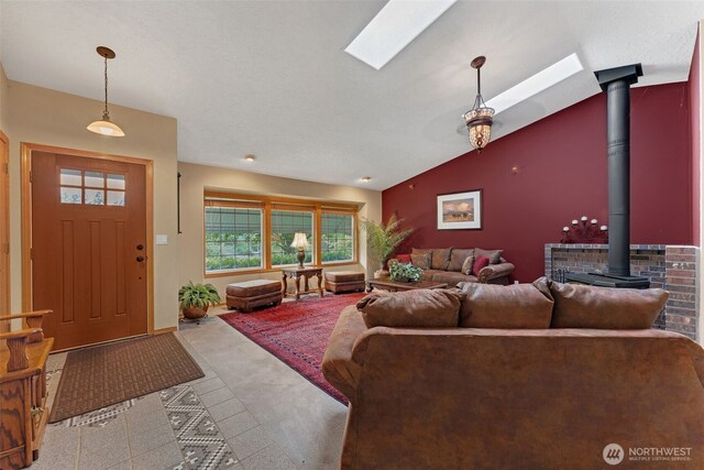 3220 N Pacific Ave, Kelso, WA 98626 - carpeted living area with a wood stove, vaulted ceiling, and a skylight