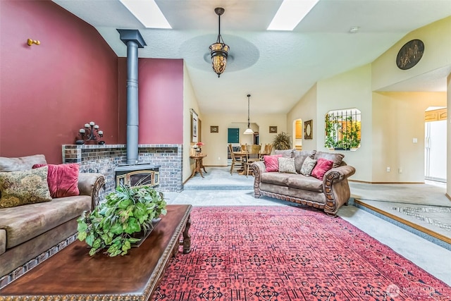 3220 N Pacific Ave, Kelso, WA 98626 - living room with lofted ceiling, carpet, a wood stove, a skylight, and baseboards