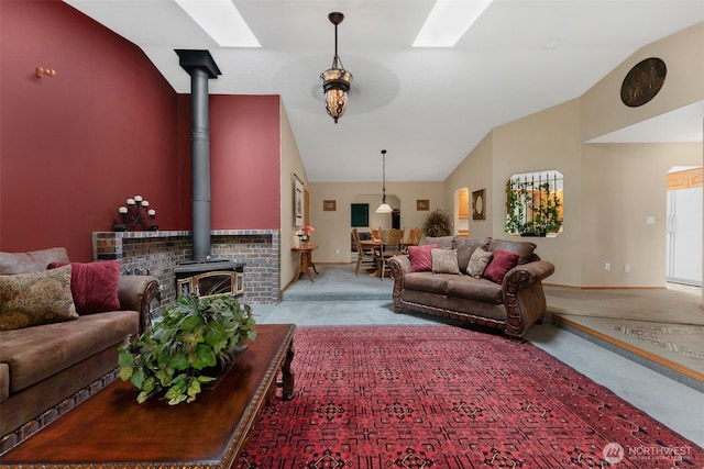 3220 N Pacific Ave, Kelso, WA 98626 - living room with lofted ceiling, a wood stove, carpet, a skylight, and baseboards
