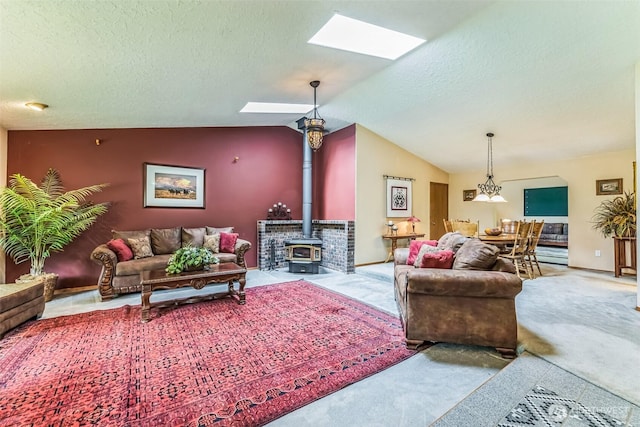 3220 N Pacific Ave, Kelso, WA 98626 - carpeted living area featuring a skylight, a wood stove, lofted ceiling, and a textured ceiling