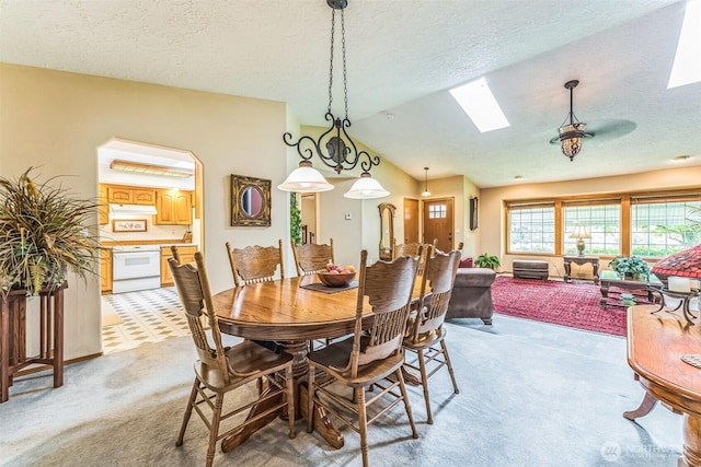 3220 N Pacific Ave, Kelso, WA 98626 - dining space featuring light carpet, a skylight, lofted ceiling, and a textured ceiling