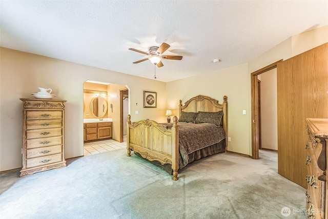 3220 N Pacific Ave, Kelso, WA 98626 - bedroom featuring arched walkways, light colored carpet, connected bathroom, and ceiling fan