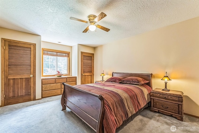 3220 N Pacific Ave, Kelso, WA 98626 - bedroom featuring light carpet, two closets, a textured ceiling, and ceiling fan
