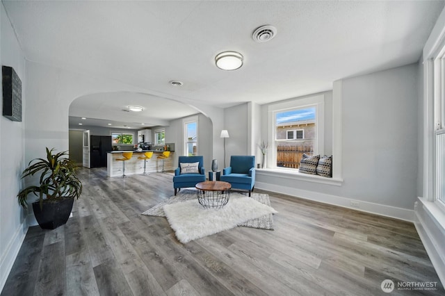 1128 W Elm St, Walla Walla, WA 99362 - sitting room with arched walkways, baseboards, and wood finished floors