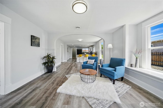 1128 W Elm St, Walla Walla, WA 99362 - sitting room with arched walkways, wood finished floors, and baseboards