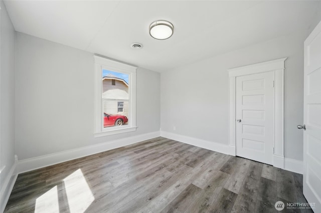 1128 W Elm St, Walla Walla, WA 99362 - empty room featuring wood finished floors and baseboards