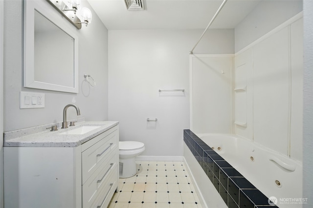 1128 W Elm St, Walla Walla, WA 99362 - bathroom featuring vanity, toilet, a combined bath / shower with jetted tub, and baseboards