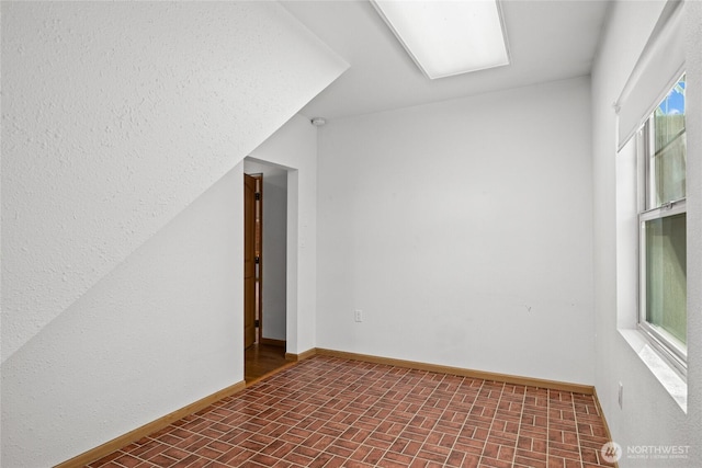 706 S A St, Roslyn, WA 98941 - unfurnished room featuring brick patterned flooring and baseboards