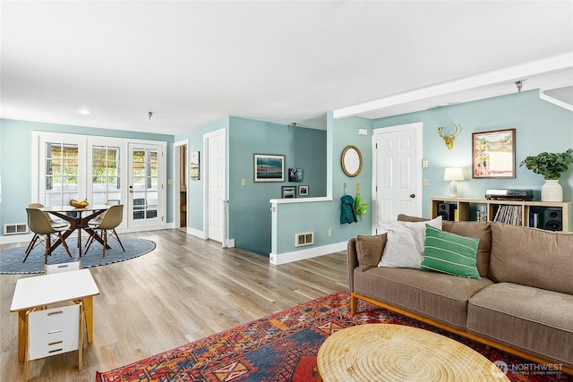 490 Madison Ave N Unit 202, Bainbridge Island, WA 98110 - living area featuring baseboards, wood finished floors, french doors, and recessed lighting