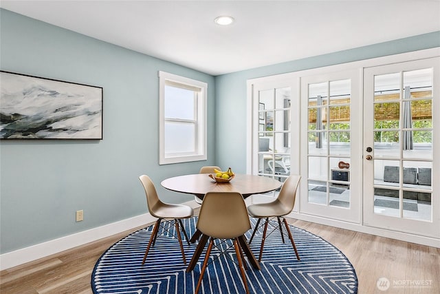 490 Madison Ave N Unit 202, Bainbridge Island, WA 98110 - dining room with french doors, healthy amount of natural light, wood finished floors, and recessed lighting