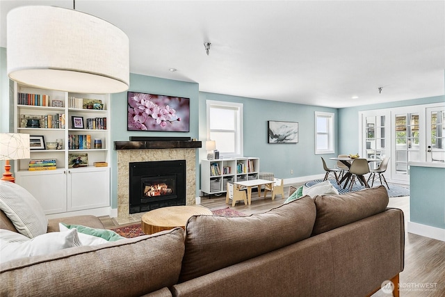 490 Madison Ave N Unit 202, Bainbridge Island, WA 98110 - living area featuring baseboards, wood finished floors, and a tile fireplace