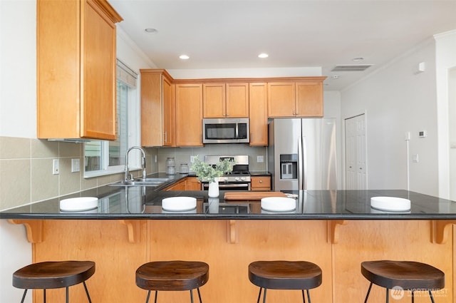 1700 235th Pl SW, Bothell, WA 98021 - kitchen with appliances with stainless steel finishes, a sink, a peninsula, dark countertops, and tasteful backsplash