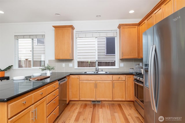 1700 235th Pl SW, Bothell, WA 98021 - kitchen with appliances with stainless steel finishes, a sink, light wood-style flooring, crown molding, and backsplash