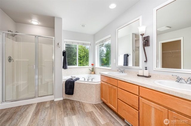 1700 235th Pl SW, Bothell, WA 98021 - bathroom featuring a stall shower, a bath, double vanity, wood finished floors, and recessed lighting
