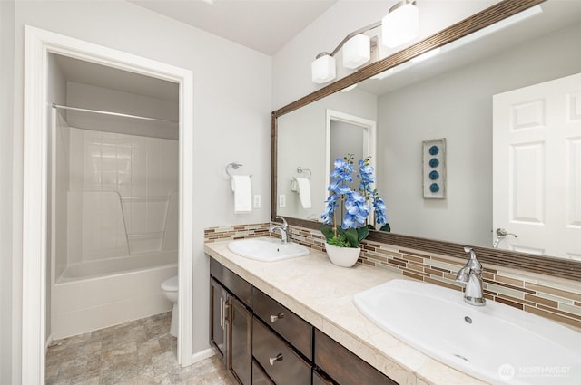 1700 235th Pl SW, Bothell, WA 98021 - bathroom featuring toilet, tasteful backsplash, double vanity, shower / bathtub combination, and stone finish floors