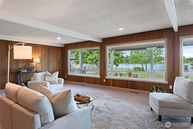 16801 Lakeside Dr S, Spanaway, WA 98387 - living room with a textured ceiling, wood walls, beamed ceiling, carpet, and recessed lighting