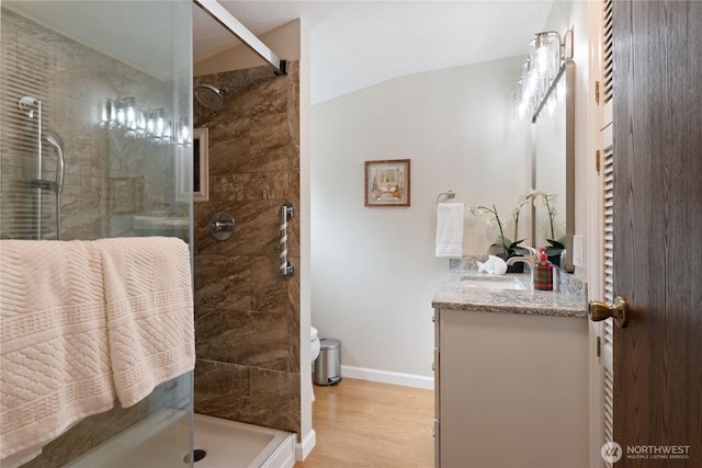 16801 Lakeside Dr S, Spanaway, WA 98387 - full bathroom with vanity, a shower stall, baseboards, wood finished floors, and lofted ceiling