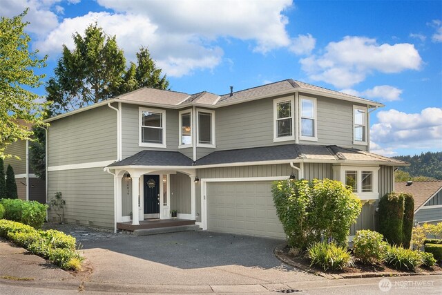 14819 1st Ave NE, Duvall, WA 98019 - traditional home with driveway, a garage, a shingled roof, and board and batten siding
