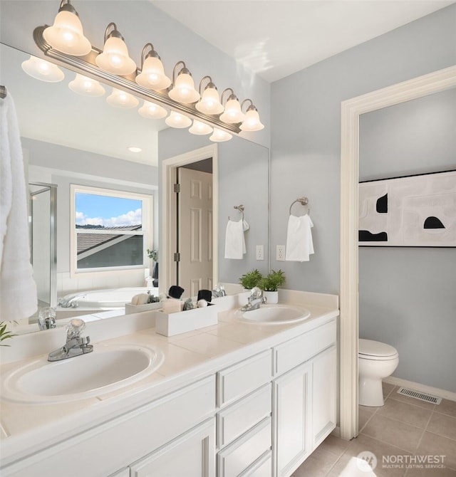 14819 1st Ave NE, Duvall, WA 98019 - bathroom featuring double vanity, tile patterned floors, a garden tub, toilet, and a shower stall
