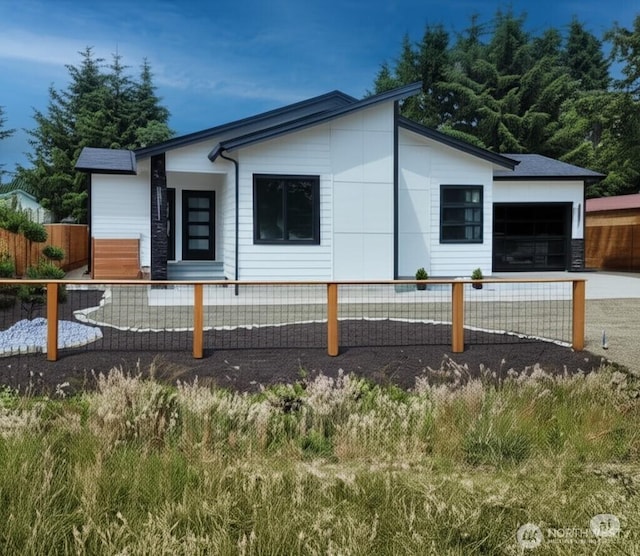 370 S Butterclam St SW, Ocean Shores, WA 98569 - view of side of home with a fenced front yard and a garage