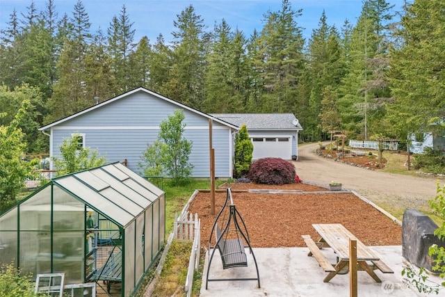 6623 NW Northridge Ln, Bremerton, WA 98312 - view of yard featuring an exterior structure, an attached garage, driveway, and an outdoor structure