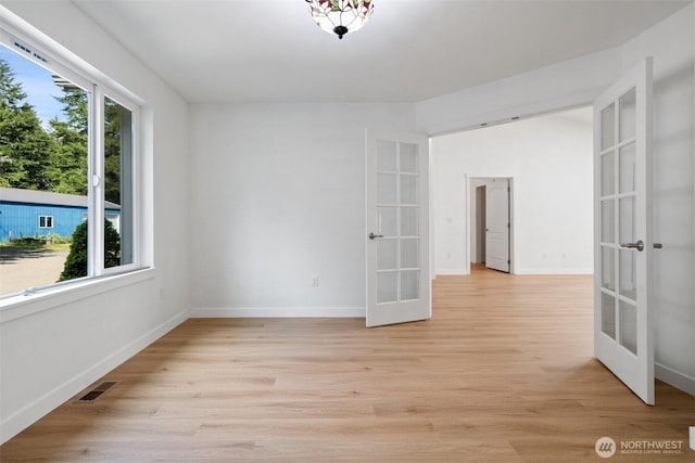 6623 NW Northridge Ln, Bremerton, WA 98312 - empty room featuring french doors, light wood-style floors, and baseboards