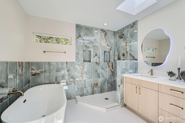 524 27th Ave, Seattle, WA 98122 - full bath with tile walls, a skylight, a walk in shower, vanity, and a freestanding tub
