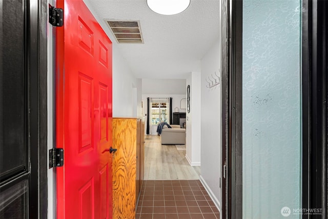 5371 Pineridge Dr NE, Bremerton, WA 98311 - hallway featuring a textured ceiling, wood finished floors, and baseboards