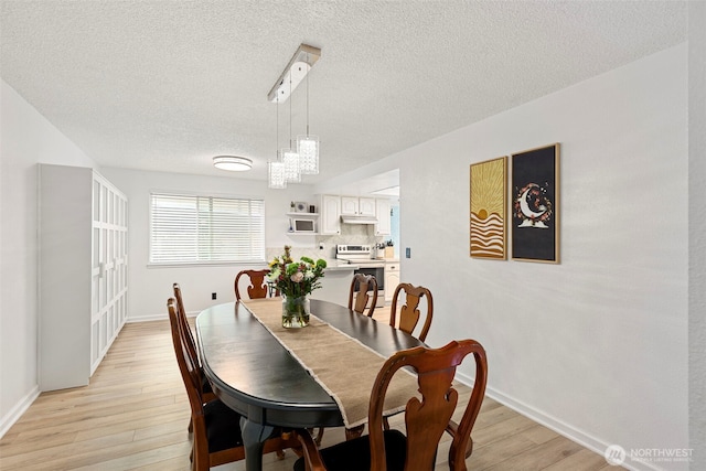 5371 Pineridge Dr NE, Bremerton, WA 98311 - dining room with a textured ceiling, light wood-type flooring, and baseboards