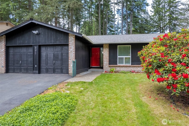 5371 Pineridge Dr NE, Bremerton, WA 98311 - view of front of house with asphalt driveway, a garage, a front lawn, and brick siding