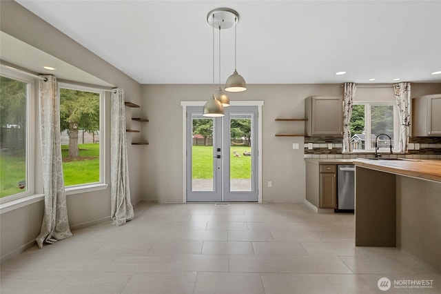 23588 Cooma Pl, Mount Vernon, WA 98274 - kitchen with stainless steel dishwasher, open shelves, a sink, tasteful backsplash, and french doors