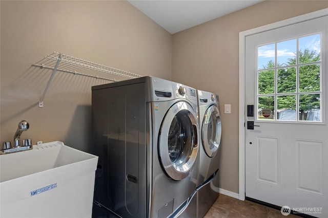 23588 Cooma Pl, Mount Vernon, WA 98274 - washroom featuring separate washer and dryer, baseboards, and dark tile patterned flooring