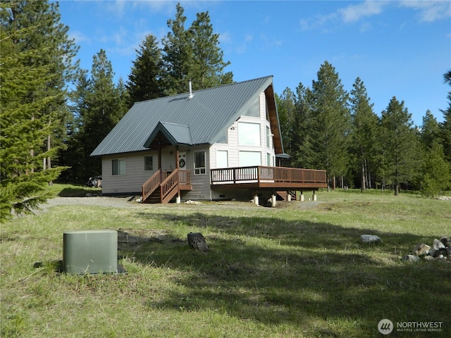302 Summer Rd, Tonasket, WA 98855 - rustic home with a front lawn, a wooden deck, and metal roof