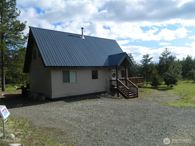 302 Summer Rd, Tonasket, WA 98855 - rear view of property featuring metal roof and driveway