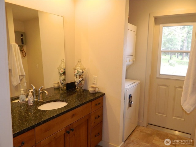 302 Summer Rd, Tonasket, WA 98855 - bathroom featuring vanity and stacked washer / drying machine