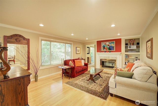 614 NW 126th Pl, Seattle, WA 98177 - living area with a fireplace, light wood-type flooring, crown molding, recessed lighting, and built in shelves