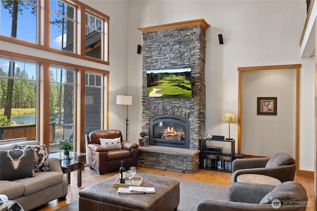 950 Coal Mine Way, Cle Elum, WA 98922 - living room with a stone fireplace, wood finished floors, and a towering ceiling