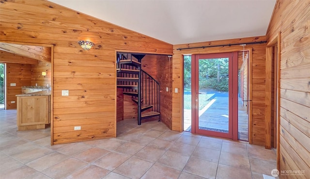 152 Richwood Ln, Lopez Island, WA 98261 - entrance foyer with wood walls, vaulted ceiling, stairway, and light tile patterned floors