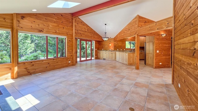 152 Richwood Ln, Lopez Island, WA 98261 - unfurnished living room featuring wooden walls and a skylight