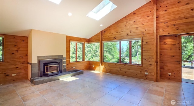 152 Richwood Ln, Lopez Island, WA 98261 - unfurnished living room with wood walls, a skylight, light tile patterned floors, high vaulted ceiling, and recessed lighting