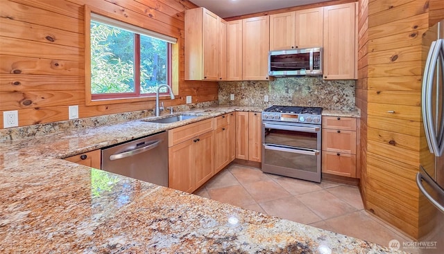 152 Richwood Ln, Lopez Island, WA 98261 - kitchen featuring appliances with stainless steel finishes, a sink, backsplash, light stone counters, and light tile patterned floors