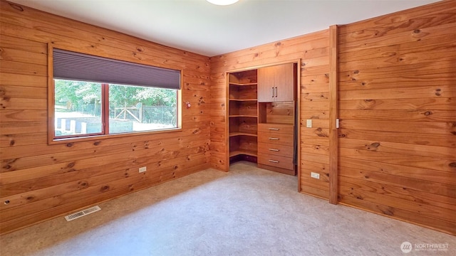152 Richwood Ln, Lopez Island, WA 98261 - unfurnished bedroom with light carpet, wood walls, and a closet