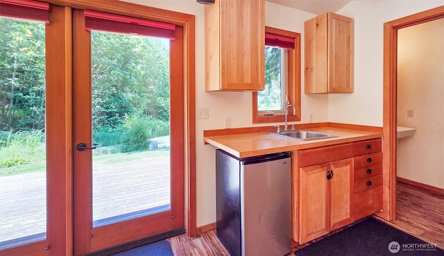 152 Richwood Ln, Lopez Island, WA 98261 - kitchen featuring light brown cabinets, a sink, fridge, baseboards, and plenty of natural light
