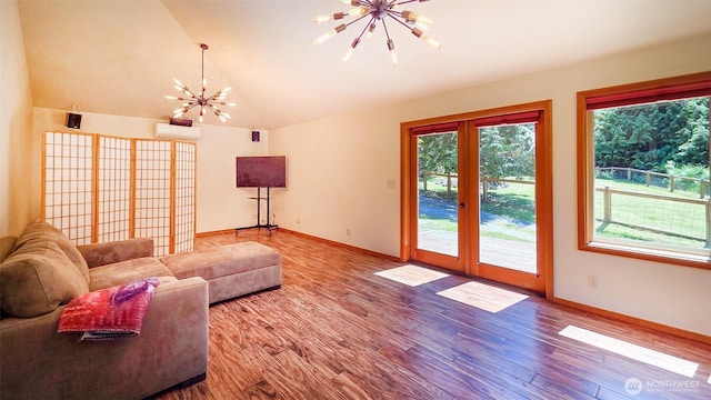 152 Richwood Ln, Lopez Island, WA 98261 - living area featuring a chandelier, healthy amount of natural light, lofted ceiling, wood finished floors, and an AC wall unit