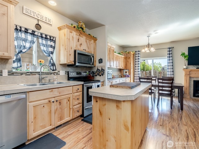 2962 26th Ave, Forest Grove, OR 97116 - kitchen featuring light brown cabinetry, stainless steel appliances, a sink, and a chandelier