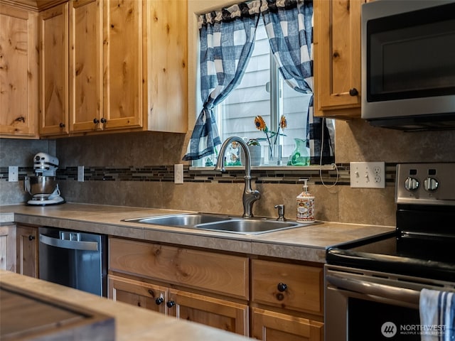 2962 26th Ave, Forest Grove, OR 97116 - kitchen with appliances with stainless steel finishes, a sink, and decorative backsplash