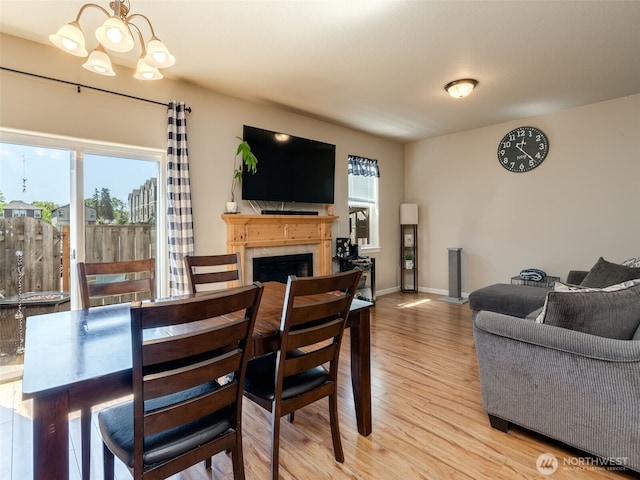 2962 26th Ave, Forest Grove, OR 97116 - dining space with wood finished floors, a chandelier, a fireplace, and baseboards