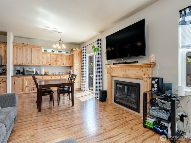 2962 26th Ave, Forest Grove, OR 97116 - dining room with a chandelier, light wood-type flooring, and a tile fireplace